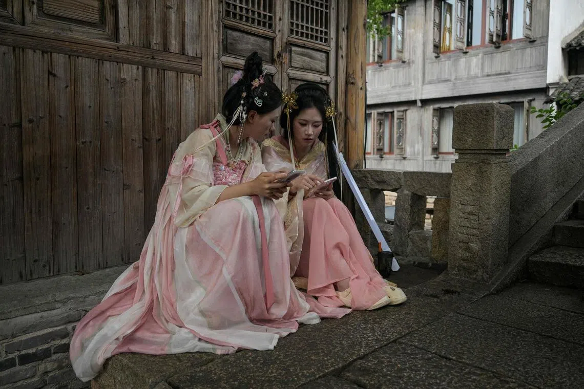 Visitors wearing traditional costumes in the scenic town of Wuzhen, in China’s eastern Zhejiang province, on June 18, 2026.