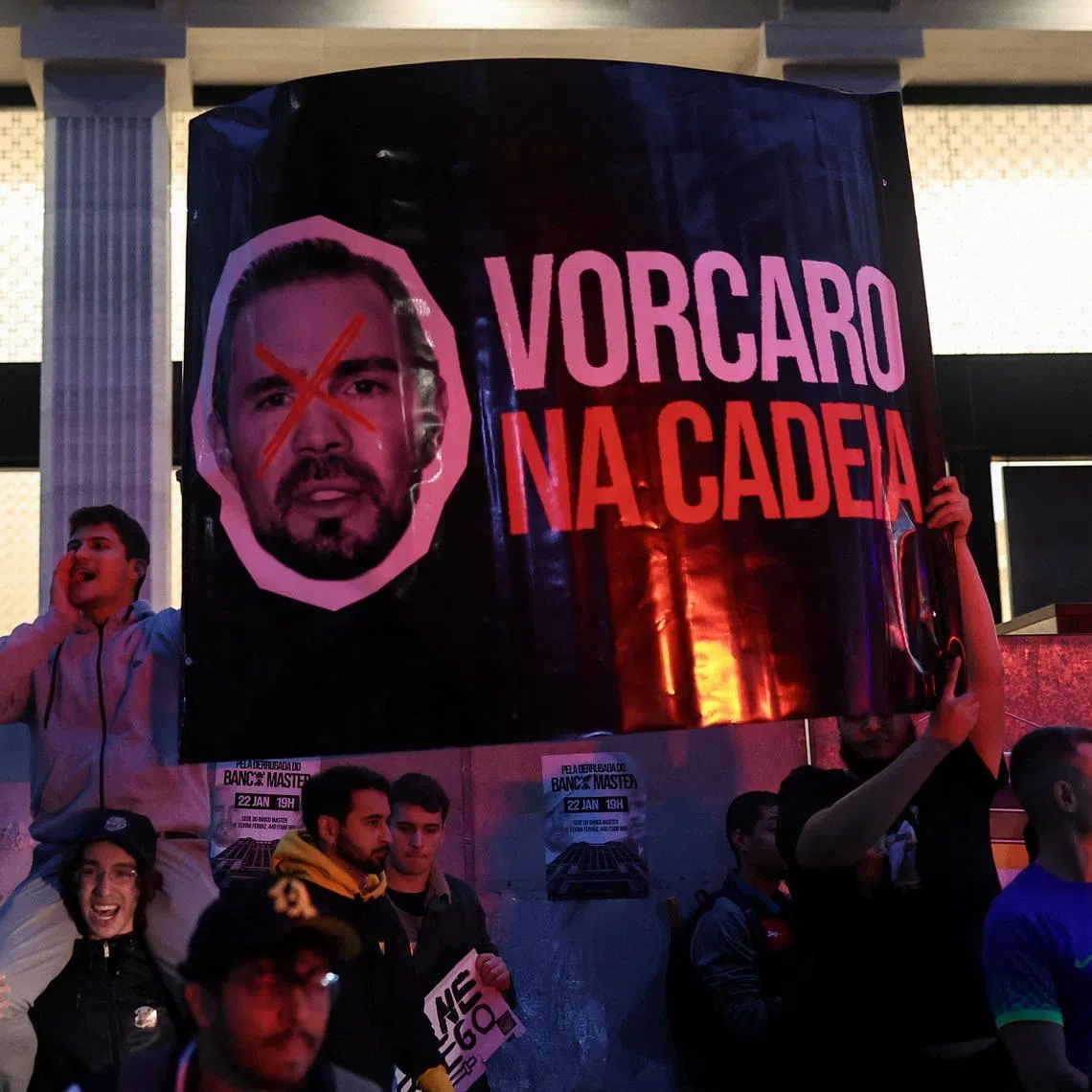 Demonstrators from the right‑wing group Movimento Brasil Livre (MBL) hold a banner reading \"Vorcaro in Jail\" depicting businessman Daniel Vorcaro as they protest outside Banco Master against alleged scandals, calling for investigation and accountability, in Sao Paulo, Brazil, January 22, 2026. REUTERS/Amanda Perobelli
