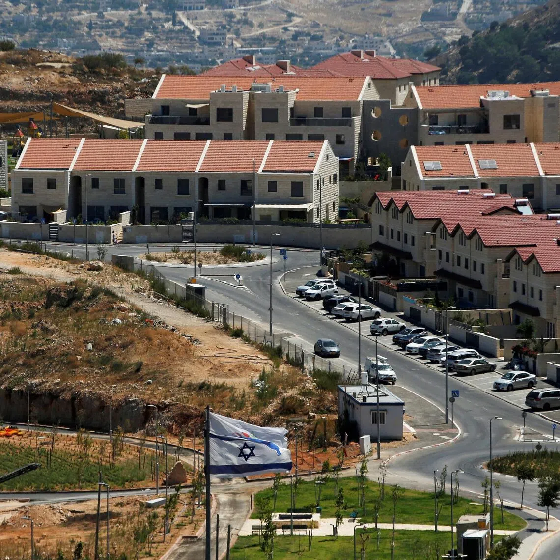 A 2020 photo shows the Israeli national flag fluttering in the Israeli settlement of Efrat, in the Israeli-occupied West Bank.