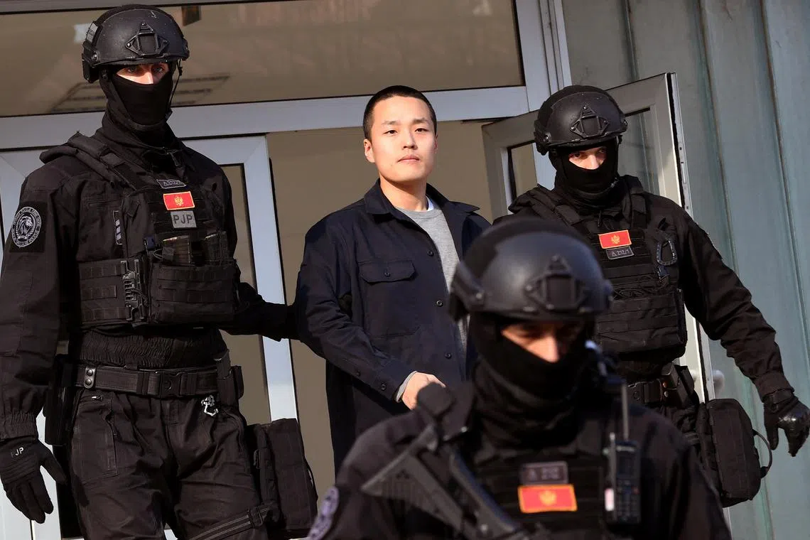 Police officers escort South Korean cryptocurrency entrepreneur Do Kwon (centre) at the exit of a court in Podgorica, Montenegro, on March 23, 2024. 