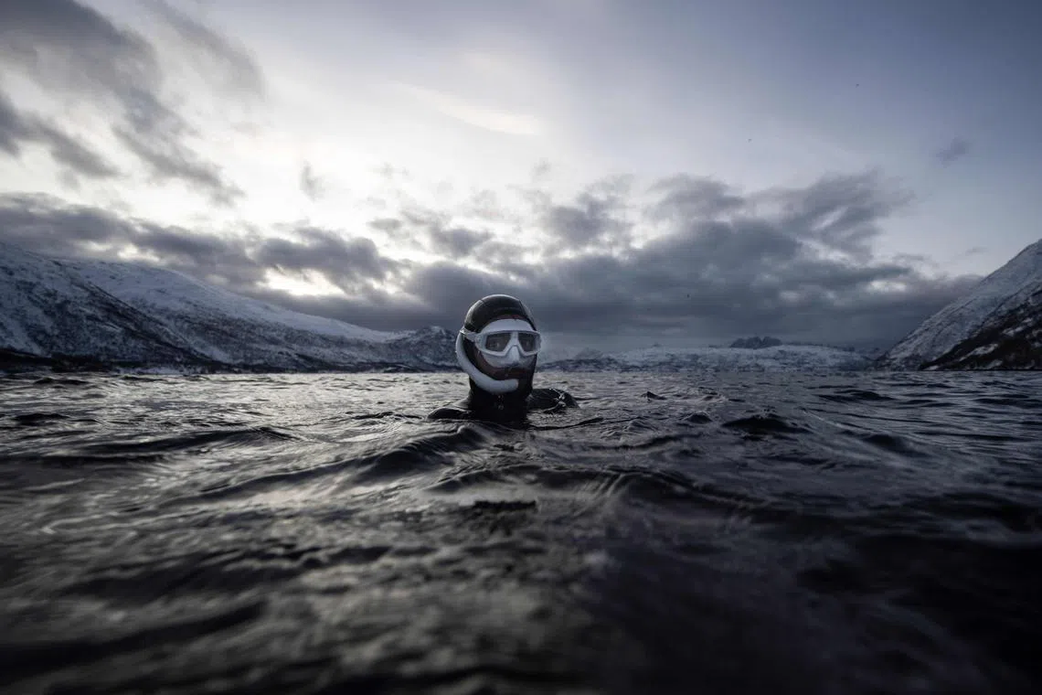 Five times freediving World Champion France's Arthur Guerin-Boeri warm up prior to dives in the deep to spot Orcas (Killer Whales), in the Spildra Island northern Arctic Circle, on Jan 25, 2023. 
