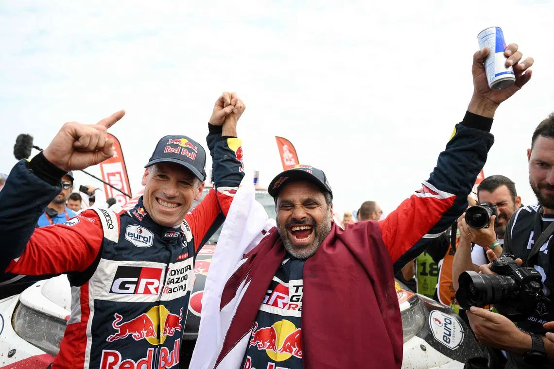 Toyota driver Nasser Al-Attiyah (right) and his co-driver Mathieu Baumel celebrate their victory after winning the Dakar Rally.