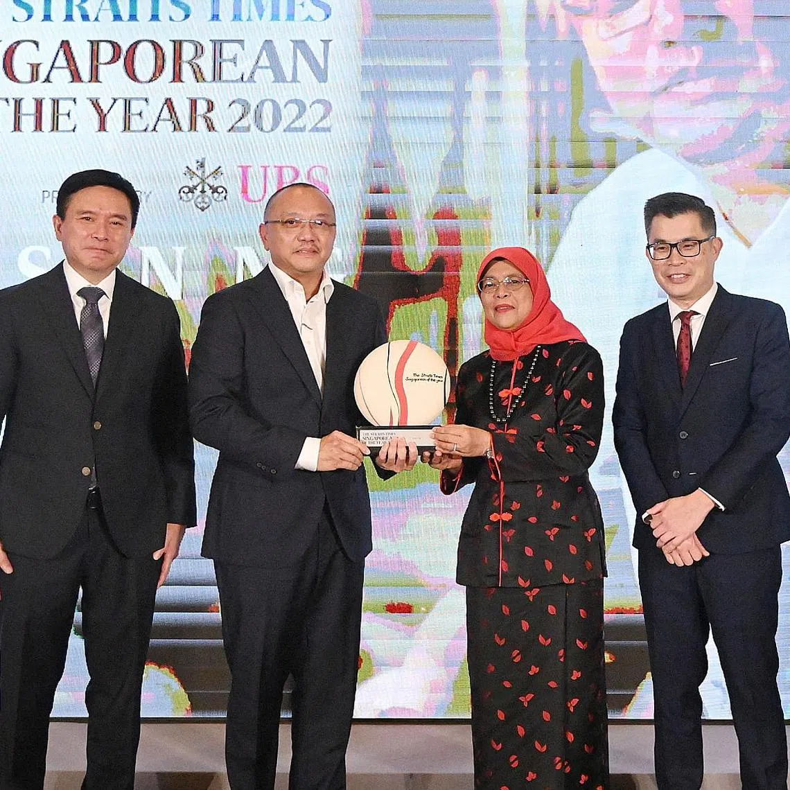 President Halimah Yacob (second right) presenting the Singaporean of the Year award to Mr Anson Ng. With them is UBS Asia-Pacific president Edmund Koh (left) and ST Editor Jaime Ho.