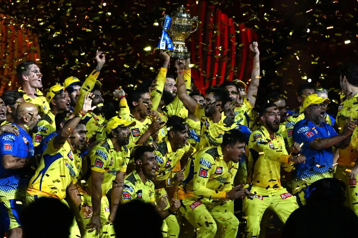 Chennai Super Kings' players celebrating with the trophy after their victory against Gujarat Titans in the Indian Premier League (IPL) Twenty20 final cricket match at the Narendra Modi Stadium in Ahmedabad.