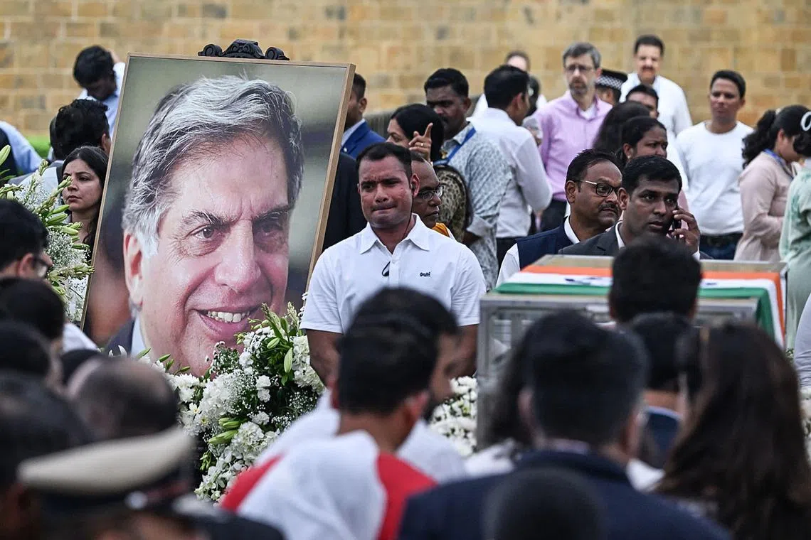 People gathered around the coffin of Indian industrialist Ratan Tata to pay their respects ahead of its cremation in Mumbai.
