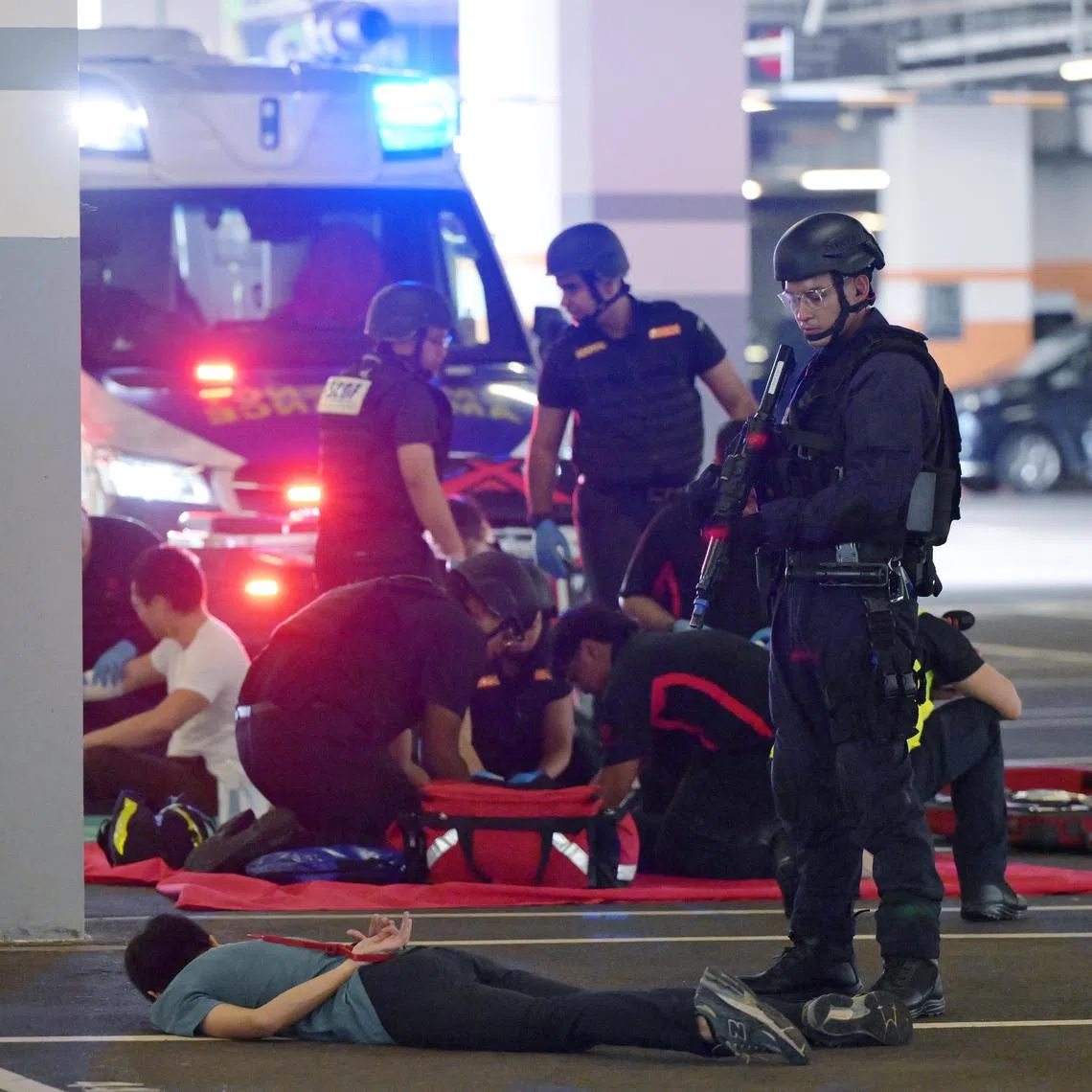 zybeat18/ ST20241118_202495200707/Ng Sor Luan/Exercise Heartbeat 2024, a police counter terrorism exercise at ITE College West on Nov 18, 2024. The SCDF sets up an area to perform triage on the injured while a police officer stands guard over a neutralized terrorist. 