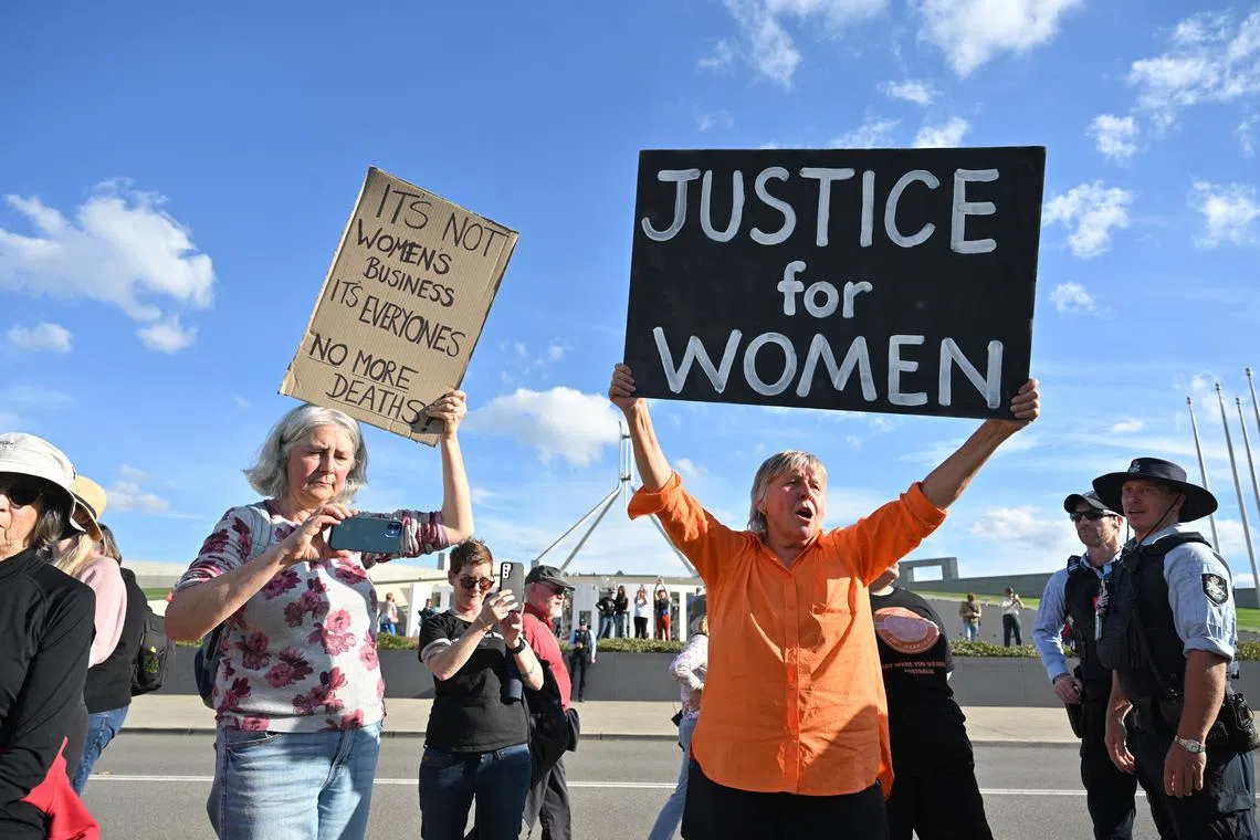 Protesters at a rally to a call for action to end violence against women, in front of the Parliament House in Canberra, on April 28.