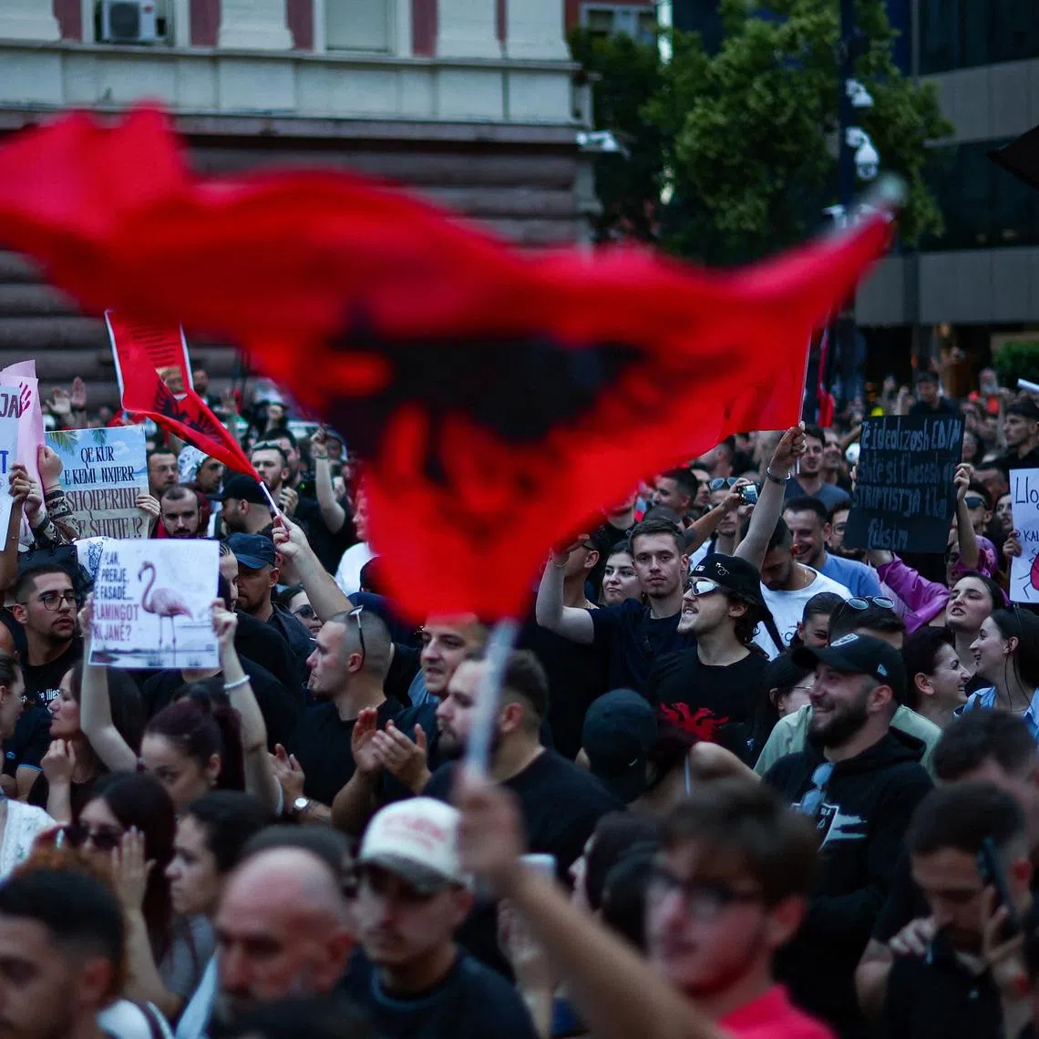 Protesters hold banners during a protest against a luxury resort development planned by a company linked with Donald Trump's son-in-law, Jared Kushner, on an environmentally sensitive part of the Adriatic coast, in Tirana, Albania, June 4, 2026. REUTERS/Florion Goga