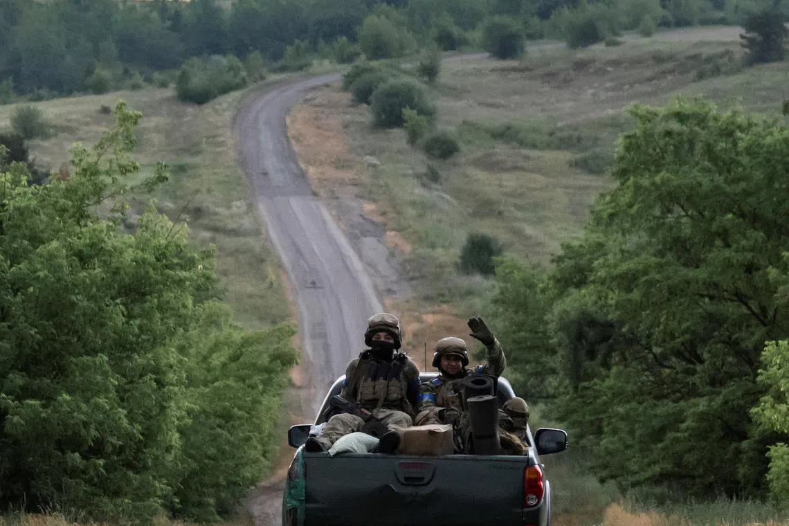FILE PHOTO: Ukrainian servicemen ride a pickup truck near the front line, amid Russia's attack on Ukraine, near the town of Vovchansk in the Kharkiv region, June 12, 2024. REUTERS/Viacheslav Ratynskyi/File Photo