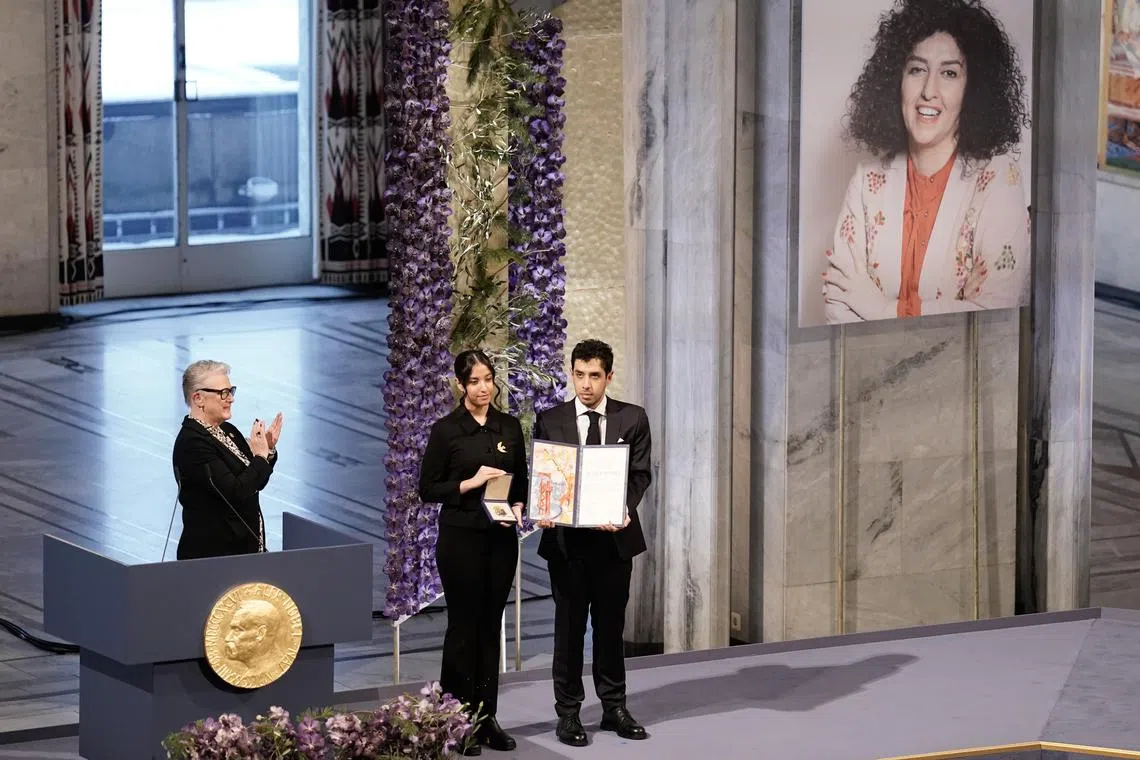 Twins Kiana (left) and Ali Rahmani receiving the Nobel Peace Prize on behalf of their mother Narges Mohammadi, who is imprisoned in Iran.