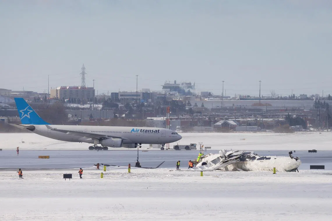 FILE PHOTO: The wreckage of a Delta Air Lines operated CRJ900 aircraft lies on the runway following a crash at Toronto Pearson International Airport in Mississauga, Ontario, Canada February 18, 2025. REUTERS/Cole Burston/File Photo