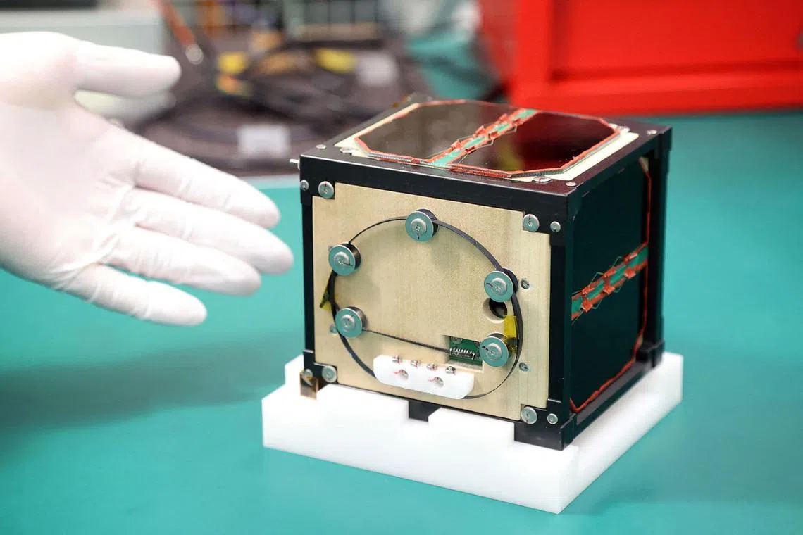The world's first wooden satellite is shown during a press conference at Kyoto University on May 28.