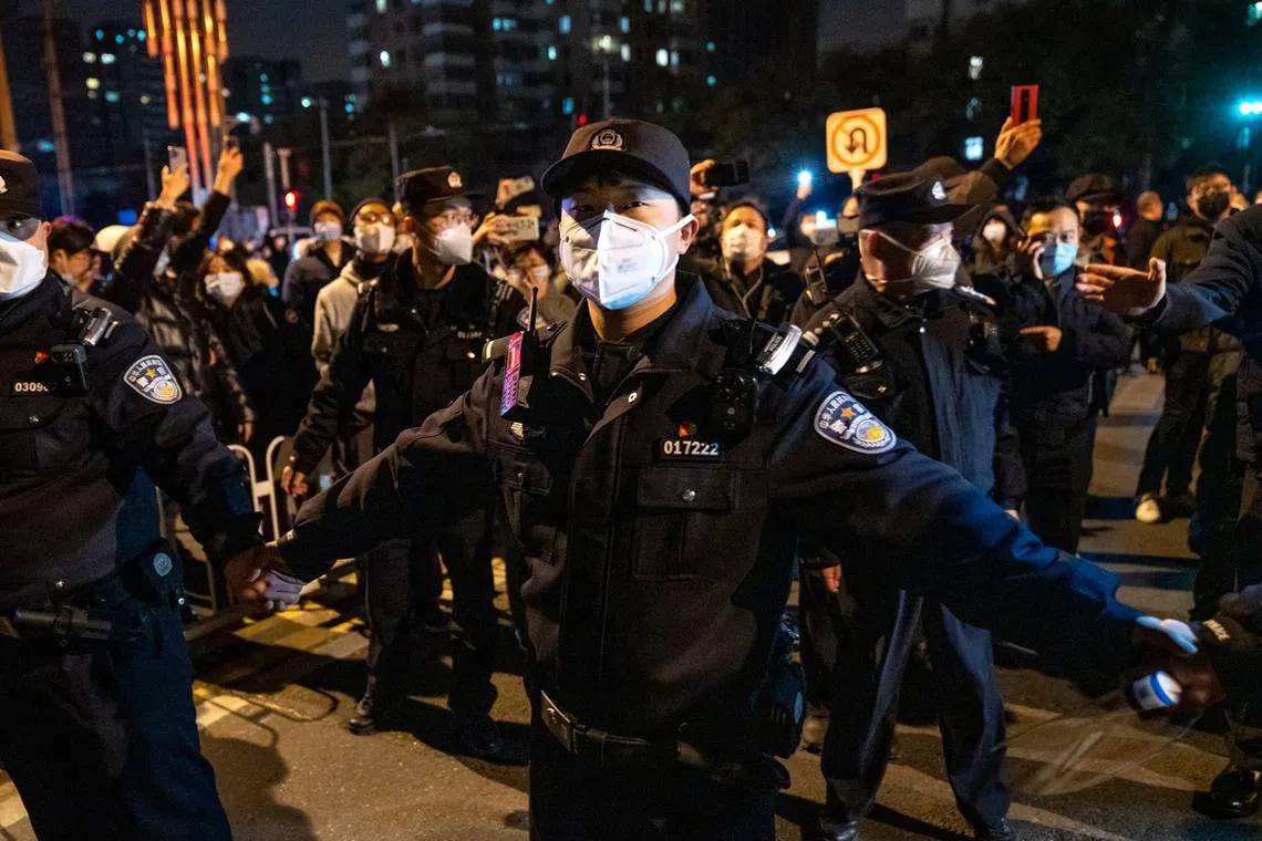 Police officers stand guard during a protest in Beijing, China, Nov 27, 2022. 