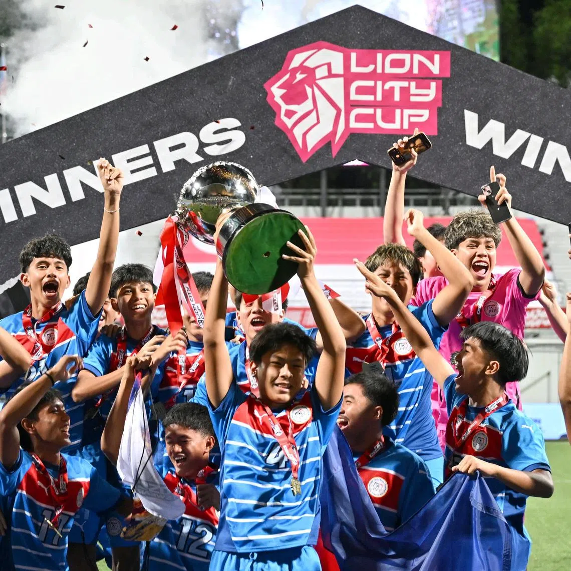 Captain Alexander Peter Lomibao lifting the trophy as the Philippines are crowned boys' champions of the 2025 Lion City Cup at Jalan Besar Stadium on Jul 13, 2025.