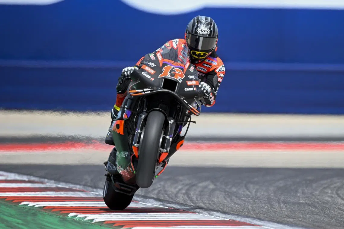 Apr 13, 2024; Austin, TX, USA; Maverick Vinales (12) of Spain and Aprilia Racing pops a wheelie during qualifying sessions for the MotoGP Grand Prix of the Americas at Circuit of The Americas. Mandatory Credit: Jerome Miron-USA TODAY Sports