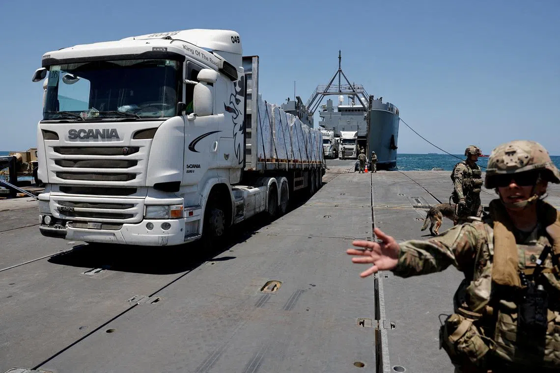 FILE PHOTO: A truck carries humanitarian aid across Trident Pier, a temporary pier to deliver aid, off the Gaza Strip, amid the ongoing conflict between Israel and Hamas, near the Gaza coast, June 25, 2024. REUTERS/Amir Cohen/File Photo