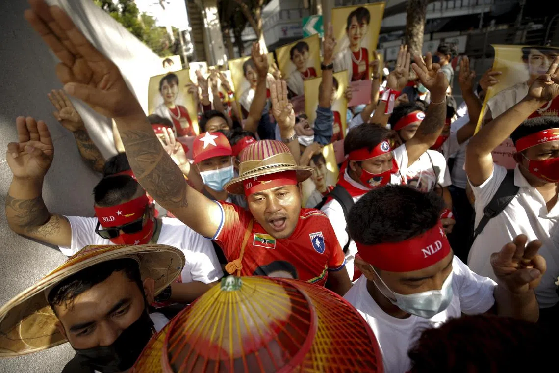 Myanmar workers living in Thailand rally outside the Myanmar embassy in Bangkok, on Dec 19, 2022.