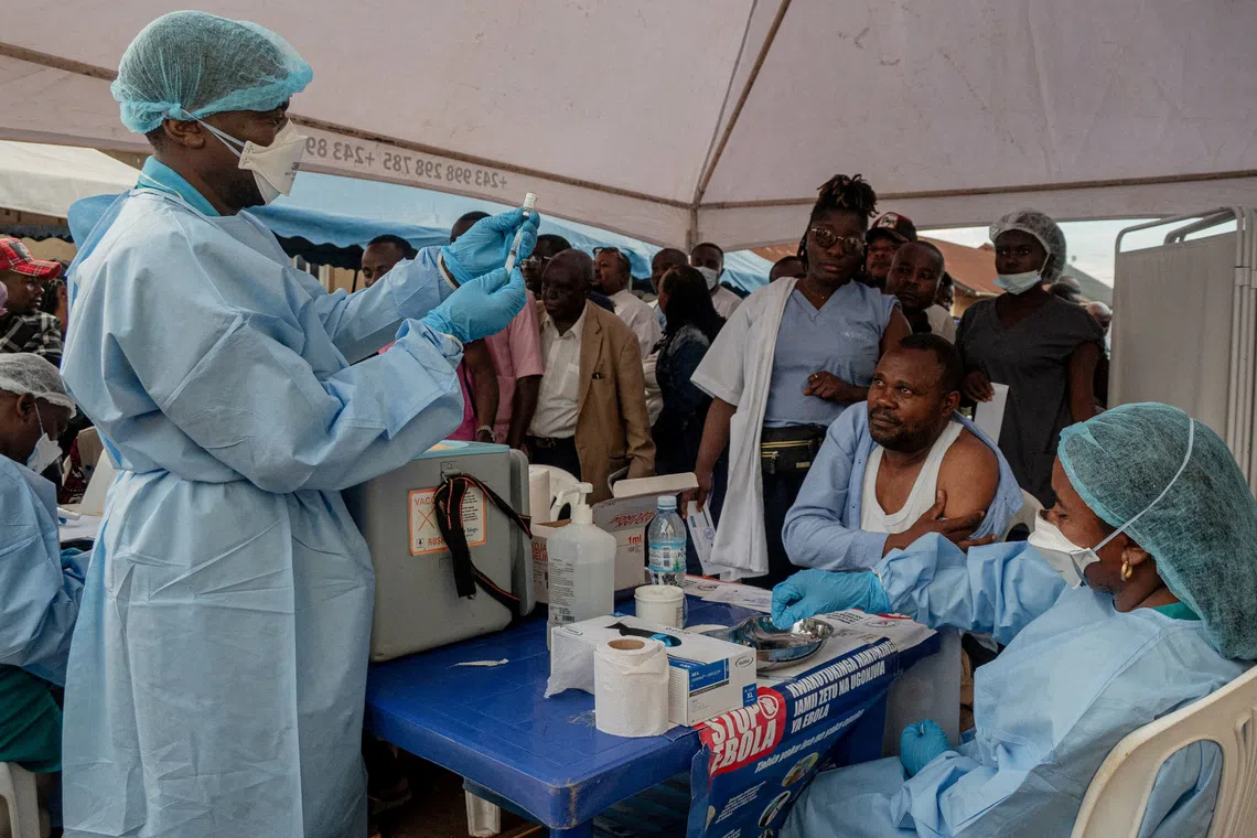 FILE PHOTO: Health workers and humanitarian responders on the front lines of the Ebola response gather to receive a vaccination due to their potential exposure to the virus as part of their work with suspected cases, including contacts, as aid agencies intensify efforts to contain the Ebola outbreak involving the Bundibugyo strain, in the North Kivu Province of the Democratic Republic of the Congo, October 16, 2026. REUTERS/Gradel Muyisa Mumbere/File Photo