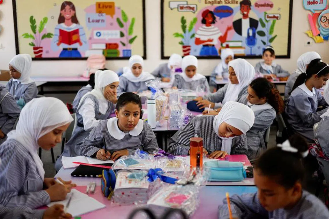 Palestinian students sit inside a class, as the United Nations-run school classes resume amid financial crisis concerns, in Gaza City August 27, 2023. REUTERS/Mohammed Salem