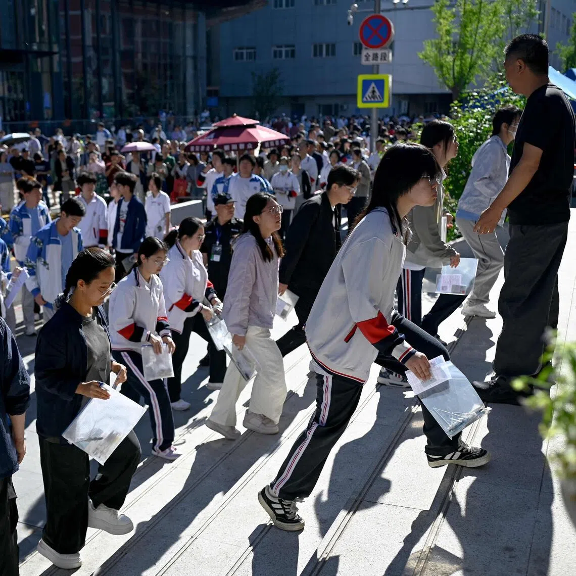 Students enter a school on the first day of China's National College Entrance Examination, known as "gaokao", in Beijing on June 7. 