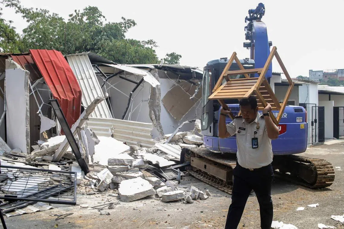 Footage showed the excavator tearing through the white-painted buildings as roofs and ceiling frames collapsed.