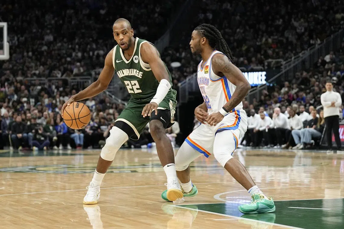 Milwaukee Bucks forward Khris Middleton dribbling past Oklahoma City Thunder guard Cason Wallace at Fiserv Forum on March 24. The Bucks won the National Basketball Association game 118-93 on the night.