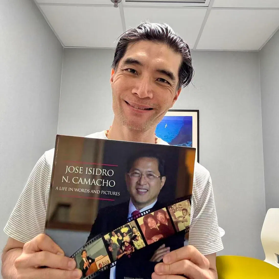 Mr Darrell Ang with a biography of Mr Jose Isidro Camacho, whose story he says brings him closer to the author.