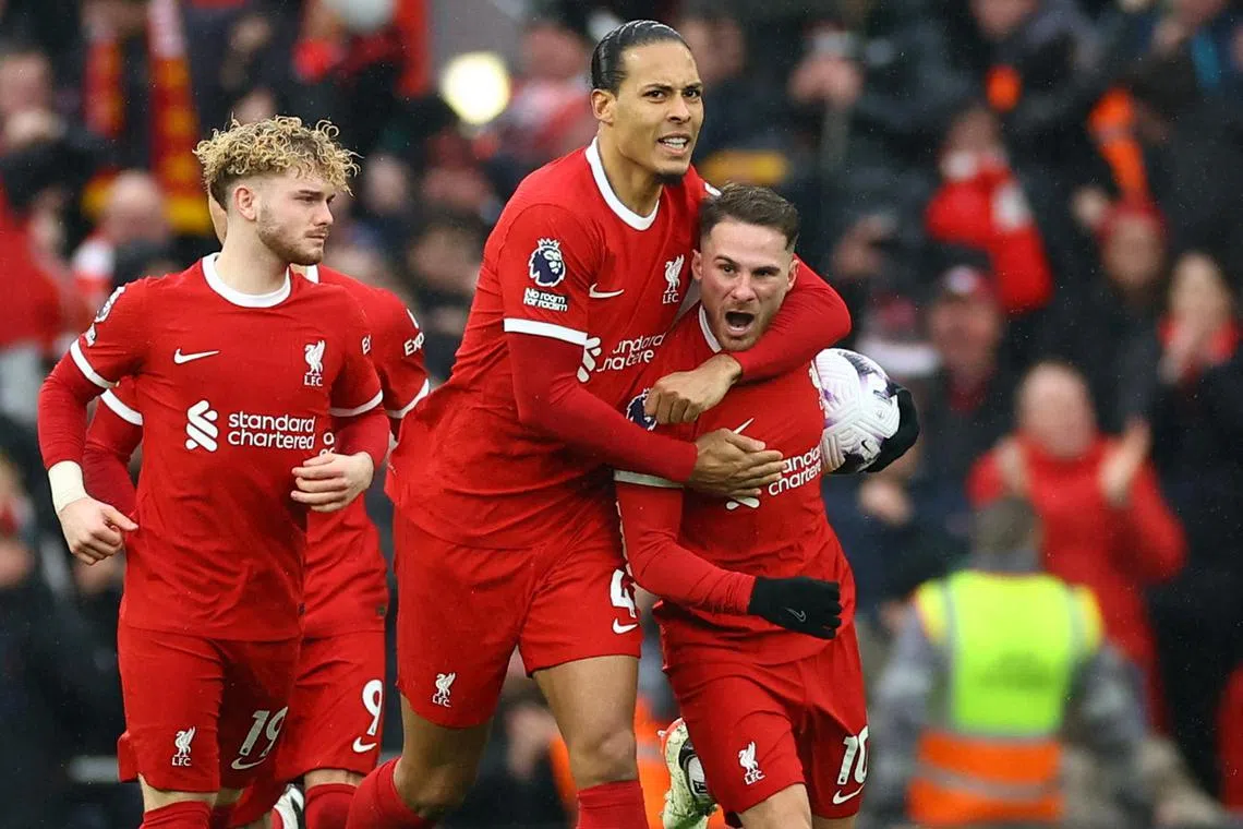 Liverpool's Alexis Mac Allister celebrating with Virgil van Dijk after scoring their first goal.
