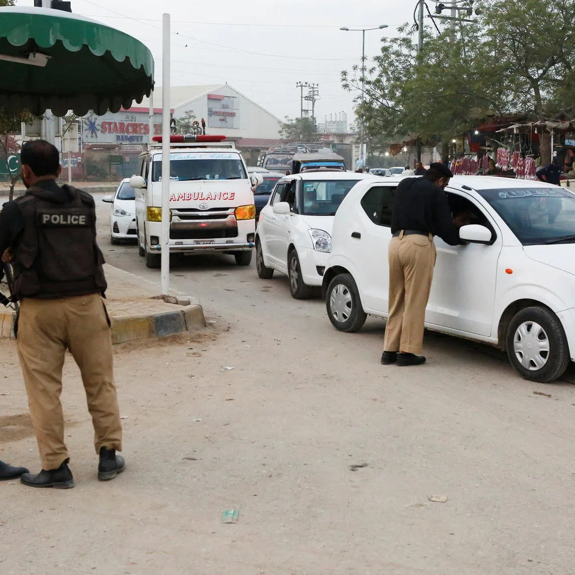 FILE PHOTO: Police officers check vehicles as a security measure, following exchanges of fire between Pakistani and Afghan forces, along a road leading to the airport in Karachi, Pakistan, February 28, 2026. REUTERS/Asim Hafeez/File Photo