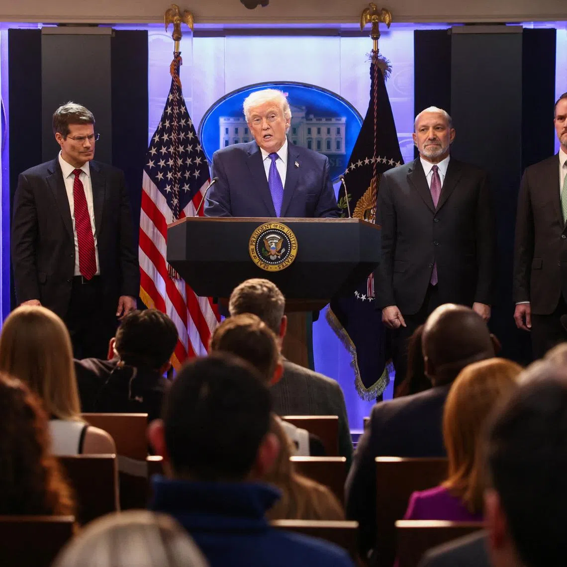 U.S. President Donald Trump, flanked by Secretary of Commerce Howard Lutnick, Trade Representative Jamieson Greer and Solicitor General D. John Sauer, speaks during a press briefing at the White House, following the Supreme Court's ruling that Trump had exceeded his authority when he imposed tariffs, in Washington, D.C., U.S., January 20, 2026. REUTERS/Kevin Lamarque