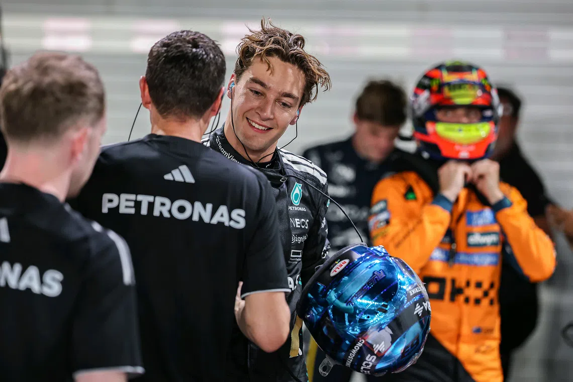 Mercedes' George Russell congratulated after clinching pole position in the qualifying session of the 2025 Formula One Singapore Airlines Singapore Grand Prix at the Marina Bay Street Circuit on Oct 4, 2025. 