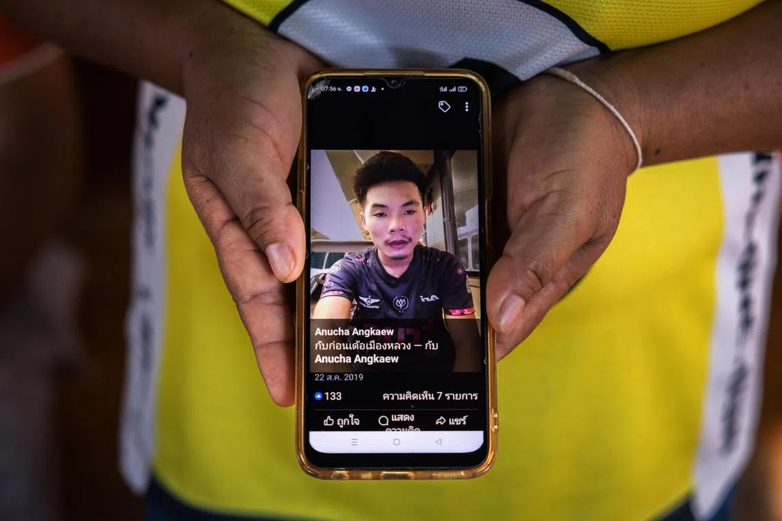 Ms Watsana Yojampa shows a photo of her son Anucha Angkaew, who was working in Israel as a farm hand when he and dozens of Thais working in the country were killed or taken hostage in the attack by Hamas, at her home in Thailand’s Udon Thani province on Thursday. 