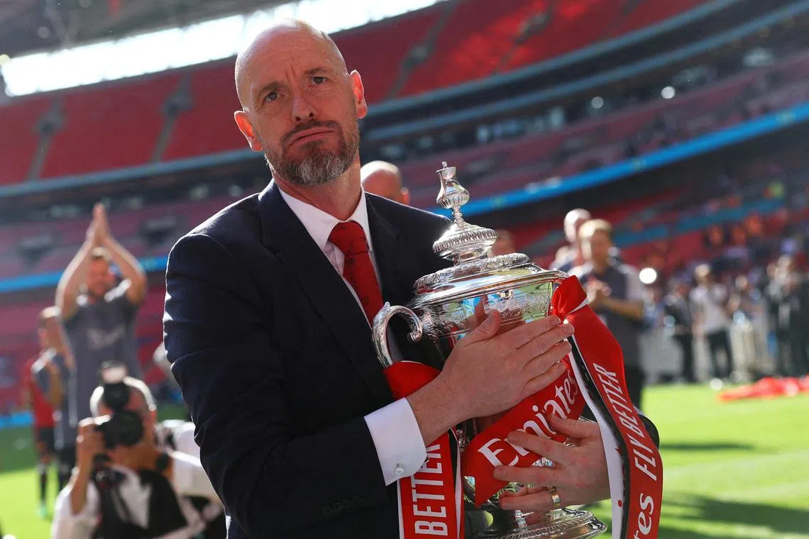Manchester United manager Erik ten Hag celebrating with the trophy after winning the FA Cup in May. He has signed a contract extension that keeps him at Old Trafford until 2026, the English Premier League club announced on July 4.