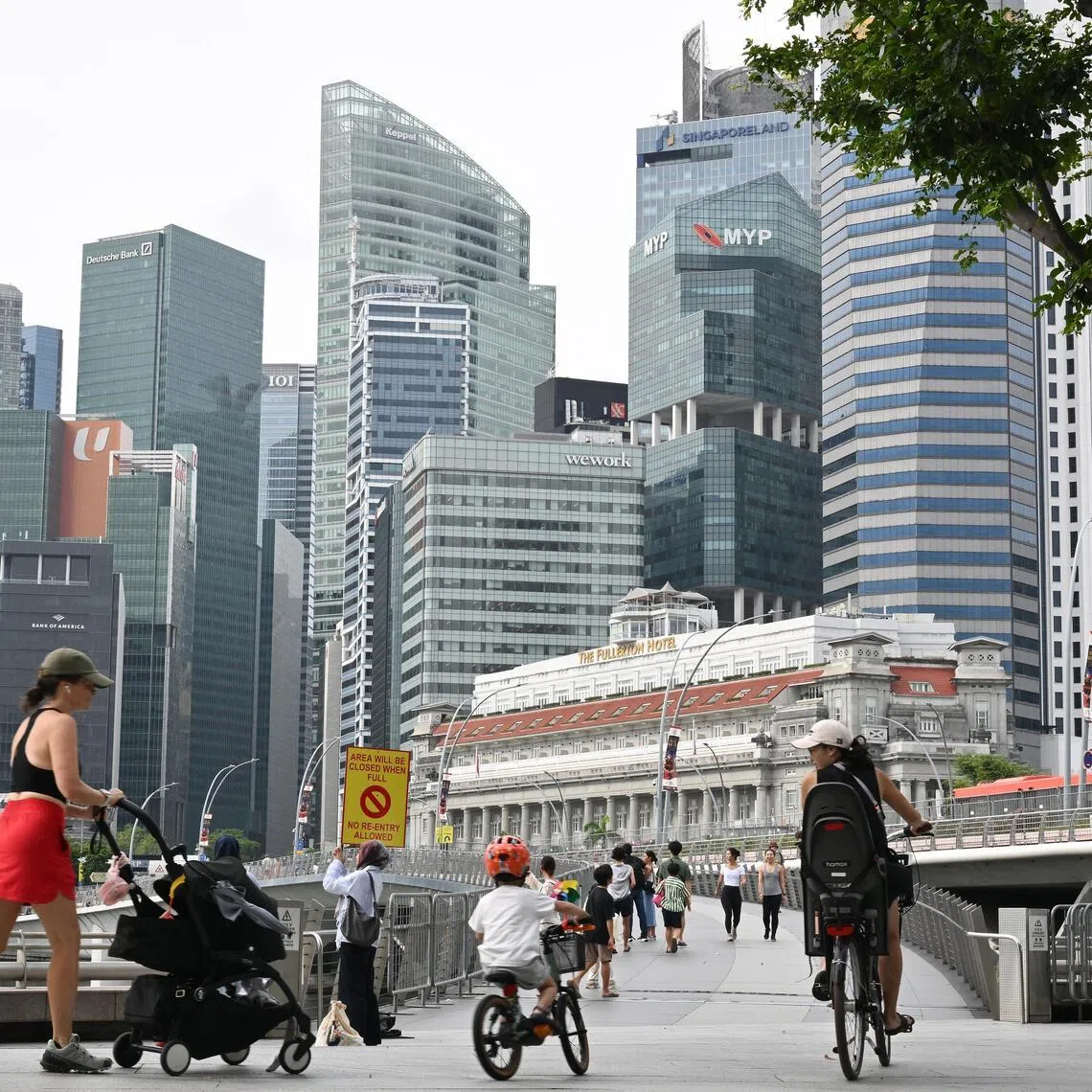ST20251231-202542800910-Lim Yaohui-pixgeneric/
People near the Jubilee Bridge with the Central Business District (CBD) skyline with the sign which says area will be closed when full on Dec 31, 2025.
Road closures and enhanced security measures will be in place during the ONE Countdown 2026 on Dec 31 until the early hours of Jan 1, with the events expected to draw huge crowds.
Celebrations and fireworks displays islandwide include those at Marina Bay and The Kallang, which was formerly known as Singapore Sports Hub. Police, auxiliary police and security officers will be deployed to manage crowds in the vicinity of Marina Bay and The Kallang, said the police on Dec 28.
To prevent overcrowding, the number of people entering certain areas will be regulated by the police and security personnel. These include The Promontory, One Fullerton/Merlion Park, Esplanade Park, Esplanade Waterfront Promenade, Marina Bay Sands Waterfront Promenade and other areas within the vicinity of Marina Bay.
Can be used for stories on family, money, property, land, tourist, tourism, commercial, office, invest, budget, income, finance, financial, CBD, URA, population, and economy.
(ST PHOTO: LIM YAOHUI)