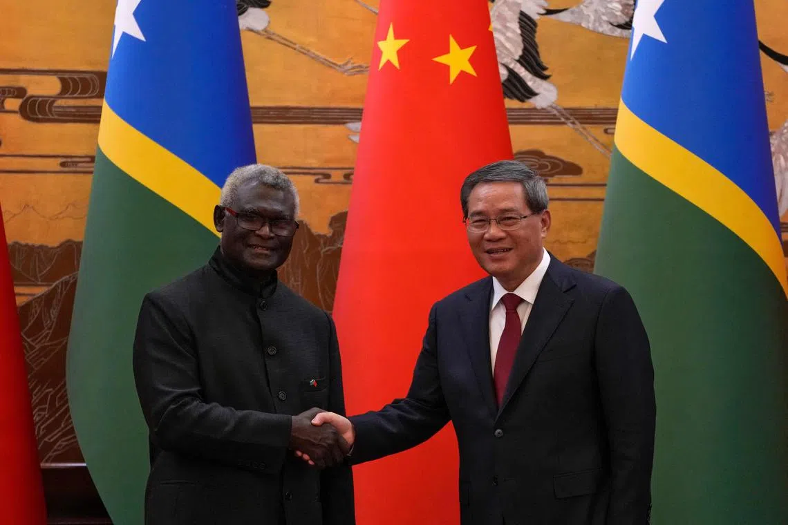 China's Premier Li Qiang (R) said the development of ties with Solomon Islands since 2019 have been very "fruitful".