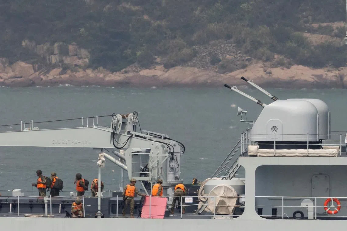 Soldiers stand on the deck of a Chinese warship as it sails during a military drill near Fuzhou.