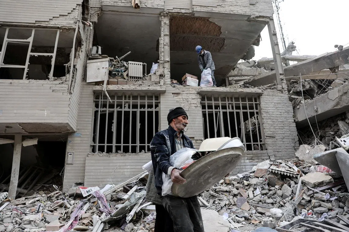 A man walks amid rubble in the aftermath of a strike, amid the U.S.-Israeli conflict with Iran, in Tehran, Iran, March 12, 2026. Majid Asgaripour/WANA (West Asia News Agency) via REUTERS