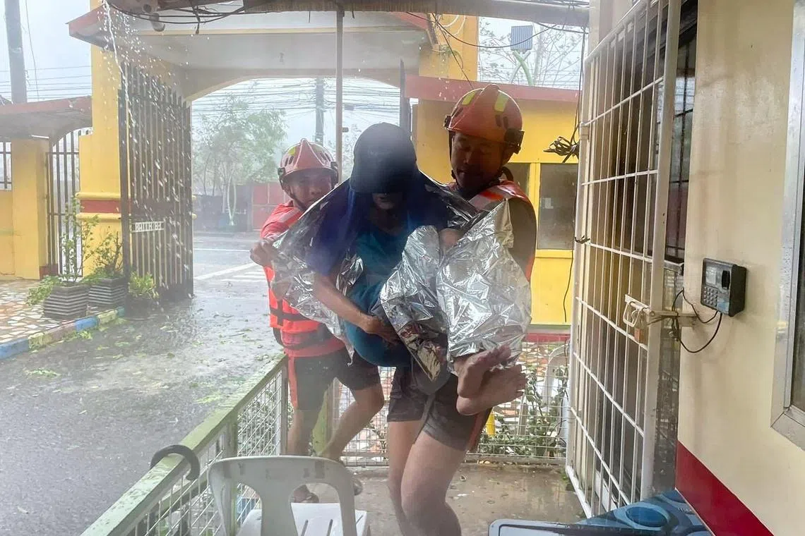 A woman was being evacuated from a flooded home by coast guard personnel in Lucena, Quezon Province, amid heavy rain brought by tropical storm Ewiniar. A severe storm battered the Philippines' most populous island on May 26, 2024 dumping heavy rain and causing flooding that forced more than 8,000 people to flee their homes.