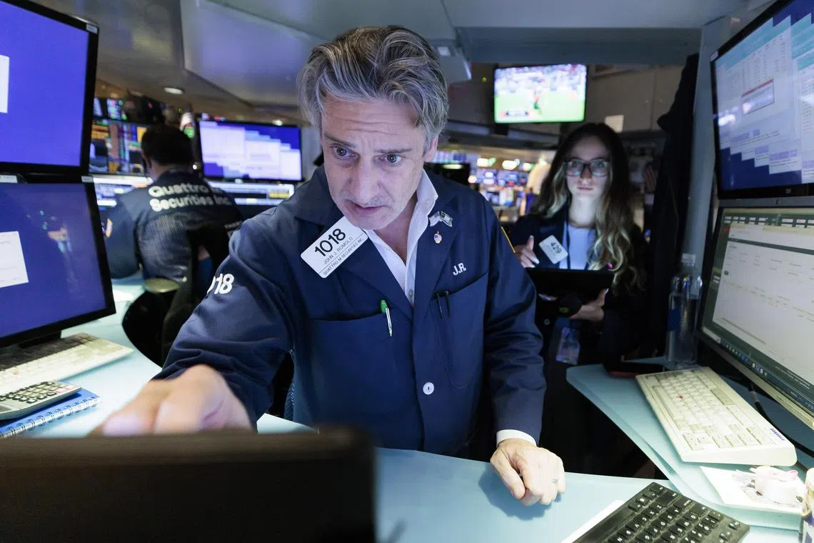 Traders work on the floor of the New York Stock Exchange.
