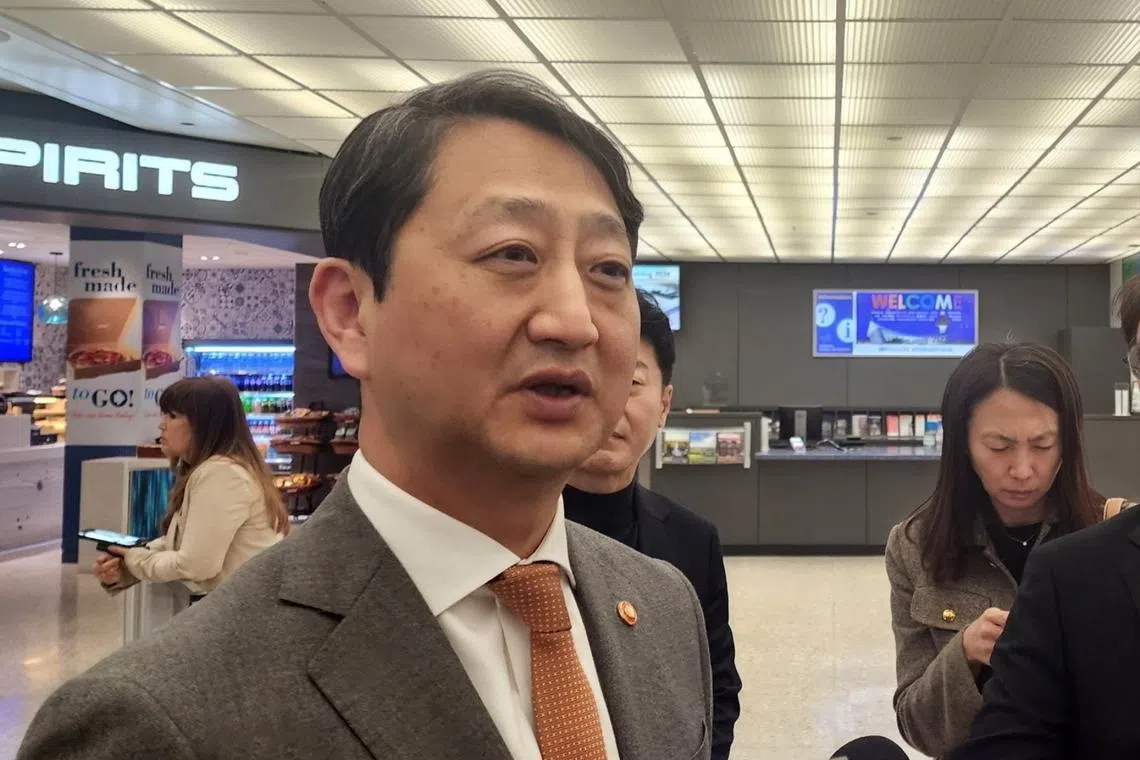 South Korean Industry Minister Ahn Duk-geun speaks to reporters after arriving at Dulles International Airport near Washington on March 20.