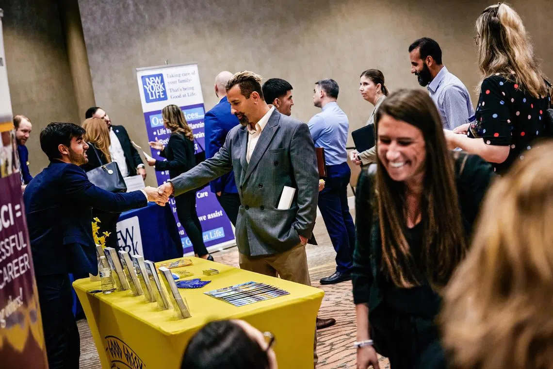 FILE Ñ Recruiters and people seeking work at a jobs fair in Miami on Feb. 20, 2024. The red-hot labor market cooled somewhat in March, government data showed on May 1. (Scott McIntyre/The New York Times)