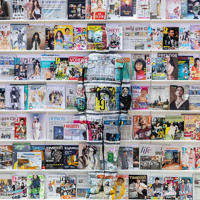 ST20250914_202513400350/pixliubolin/Brian Teo/Beijing-based contemporary artist Liu Bolin is photographed against a backdrop of SPH Media newspapers and magazines during the Canvas of Hope initiative by the Rare Disorders Society (Singapore) [RDSS] at the Glass Dome, Far East Square, on Sept 14, 2025. The art-meets-advocacy campaign, Liu’s first collaboration with a Singapore charity, aims to spotlight the lives of children with rare diseases and raise S$1 million for therapy, medical equipment and caregiving support for over 200 patients. For Canvas of Hope 2025, a Singapore chapter was created using The Straits Times and other SPH titles, marking both The Straits Times’ 180th anniversary and Singapore’s 60th year of independence. The artwork honours the media’s role in chronicling the nation’s stories while prompting reflection on which narratives are visible and which remain unseen. ST PHOTO: BRIAN TEO