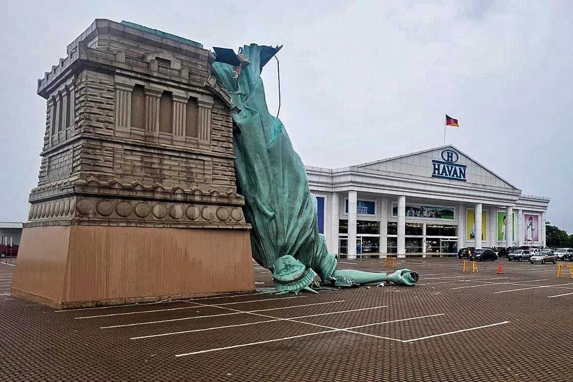 A replica of the Statue of Liberty that collapsed onto a carpark amid severe weather in the Brazilian state of Rio Grande do Sul.