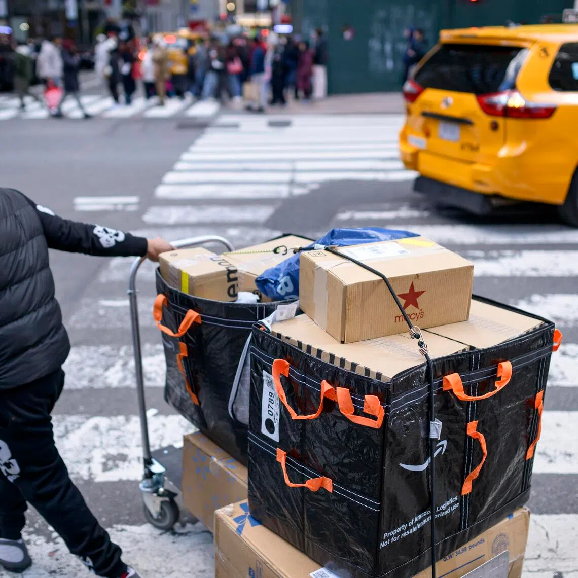 An Amazon logistics delivery person navigates 5th Avenue on Black Friday in Manhattan, on Nov 28. 