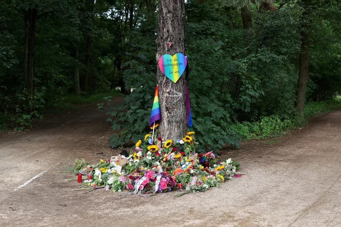 A view of a makeshift memorial at Tiergarten park after a deadly incident in which a vehicle crashed into a crowd near Berlin's annual Christopher Street Day Pride parade on Saturday evening, leaving multiple people injured and the parade called off, in Berlin, Germany, July 27, 2026. The placard reads: \"We honor all the victims and survivors. We will not allow ourselves to be divided\". REUTERS/Christian Mang