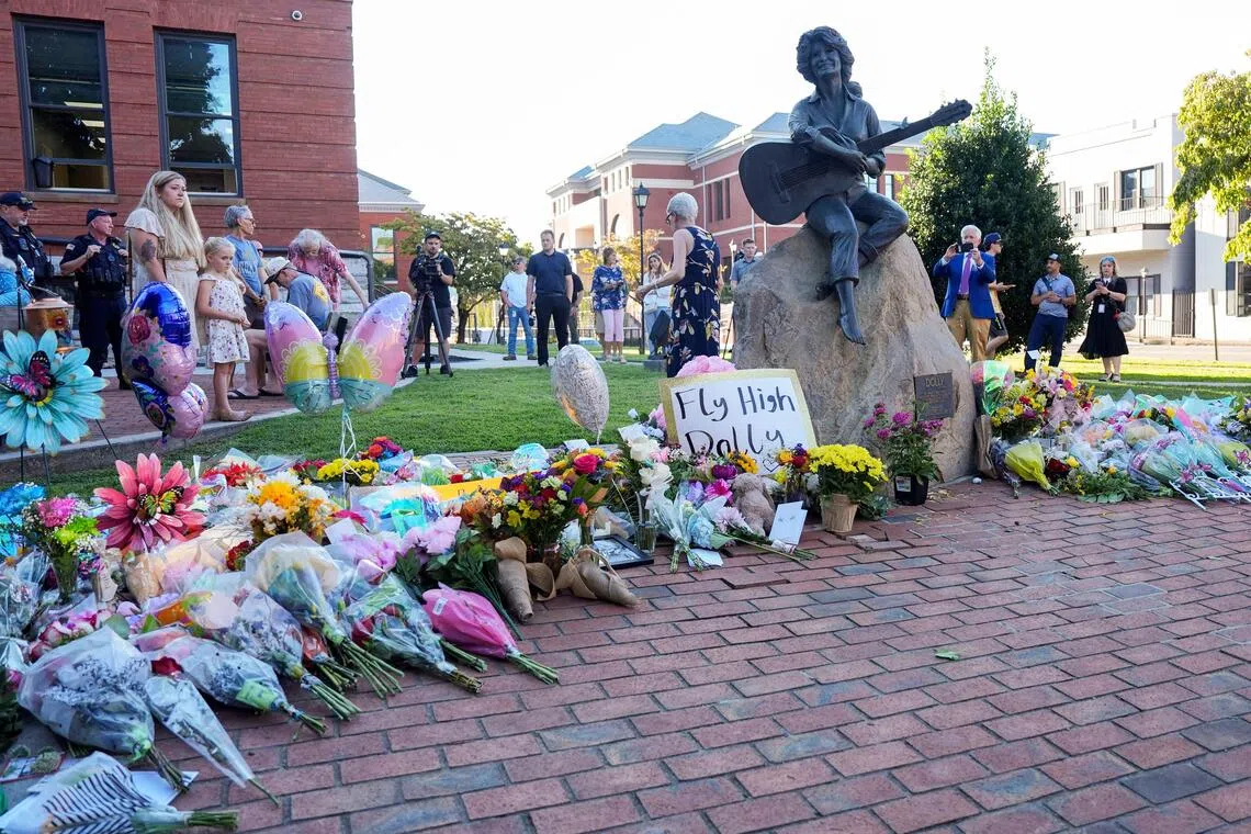 Mourners pay their respects to Dolly Parton after the announcement of her passing, at the Dolly Parton Statue in downtown Sevierville, Tennessee, US on Aug 25.