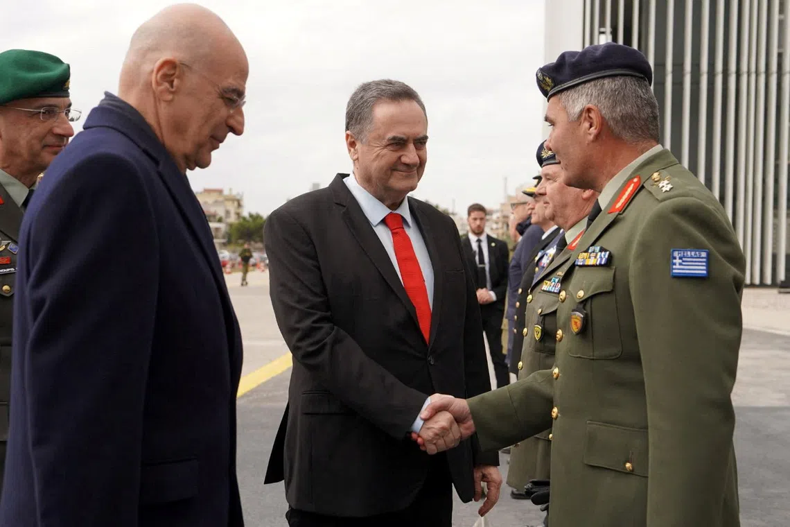 Israel Defence Minister Israel Katz shakes hands with General Director of the General Directorate for Defence Investments and Armaments (GDDIA) of Greece, Major General Ioannis Bouras, next to Greece's Minister for National Defence Nikolaos Dendias, during a visit in Greece on January 2026 in this handout image obtained by Reuters on August 31, 2026.  Israel Defence Ministry/Handout via REUTERS