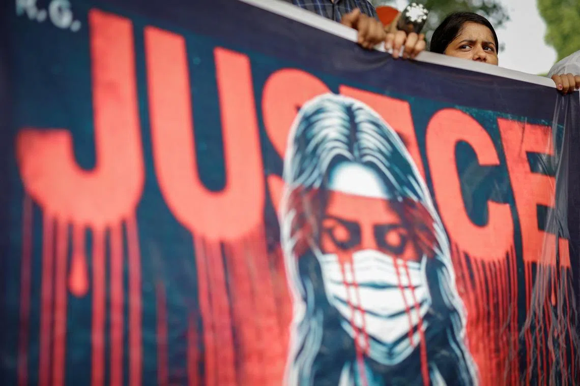 FILE PHOTO: A doctor holds a banner during a protest demanding justice following the rape and murder of a trainee medic at a hospital in Kolkata, in New Delhi, India, August 19, 2024. REUTERS/Adnan Abidi/File Photo