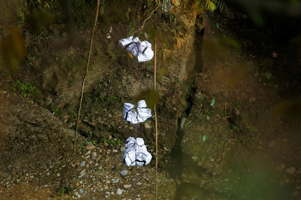 A rescue team recovers the bodies of victims from the site of the plane crash of a Yeti Airlines-operated aircraft, in Pokhara, Nepal, Jan 16, 2023. 