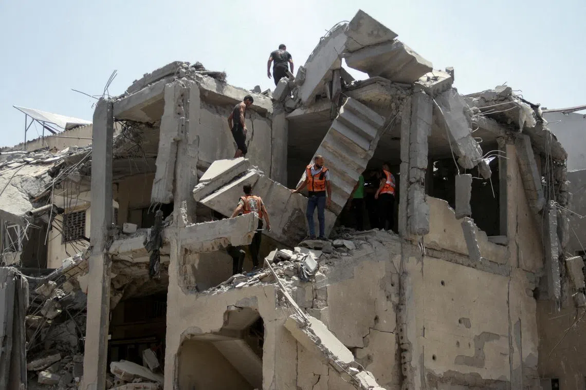 Palestinian rescuers work to evacuate casualties from a residential building hit by Israeli strikes which destroyed shops at Gaza's Old City market, amid the Israel-Hamas conflict, in Gaza City July 4, 2024. REUTERS/Mahmoud Issa/File Photo